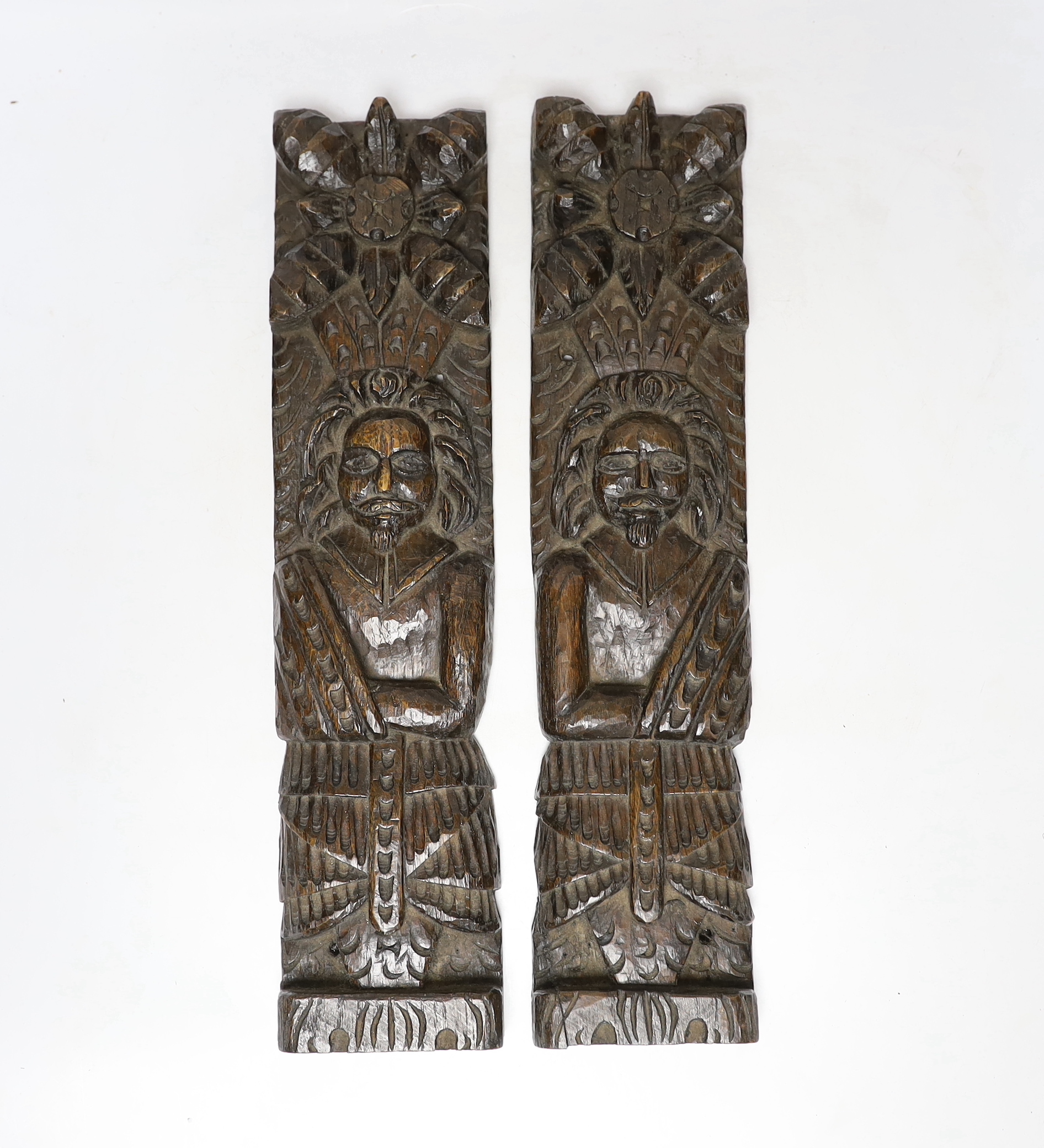 A pair of 17th century carved oak figural jambs, 43.5cm